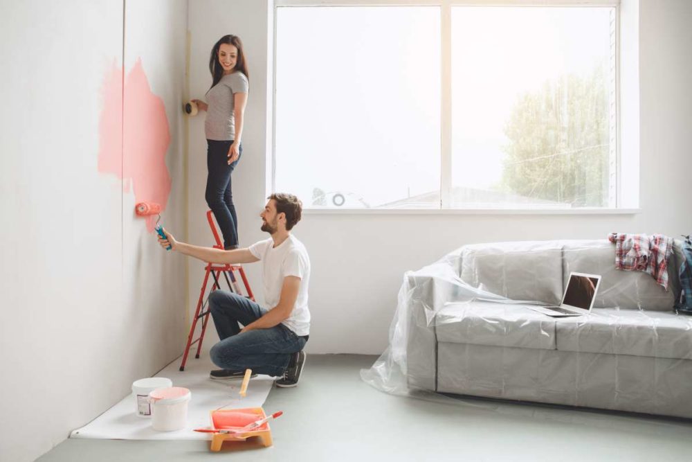 Couple painting their living room